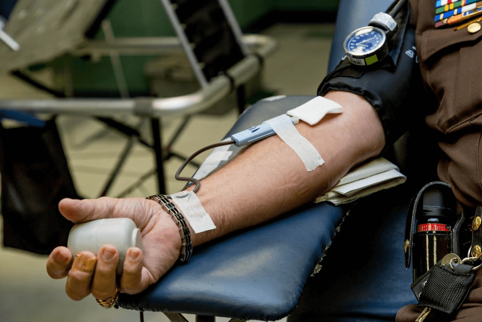 person on chair donating blood