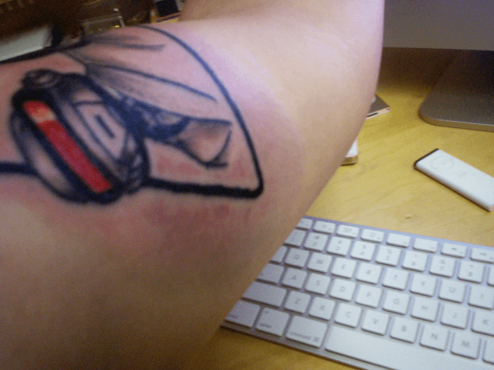 A tattoo of a computer keyboard
Description automatically generated